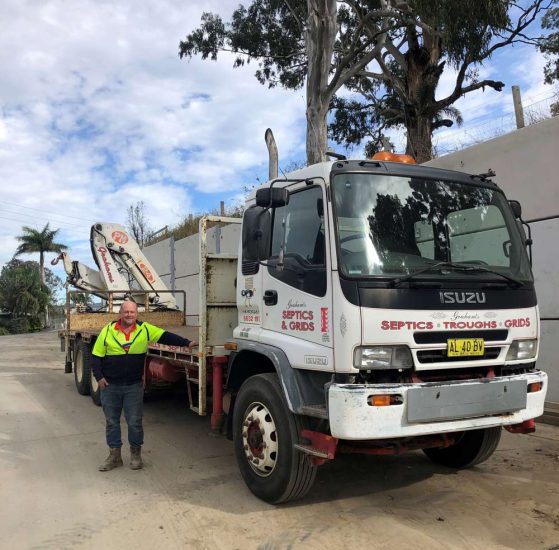 Man Smiling Besides the ISUZU Truck — Concrete Products in Kyogle, NSW