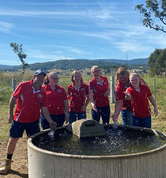 Workers in red uniform having fun — About Us in Kyogle, NSW
