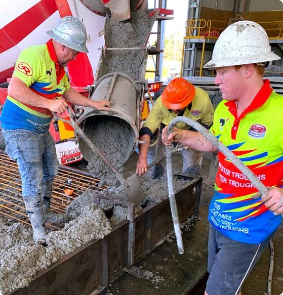 Construction workers pouring cement — Concrete Products in Kyogle, NSW